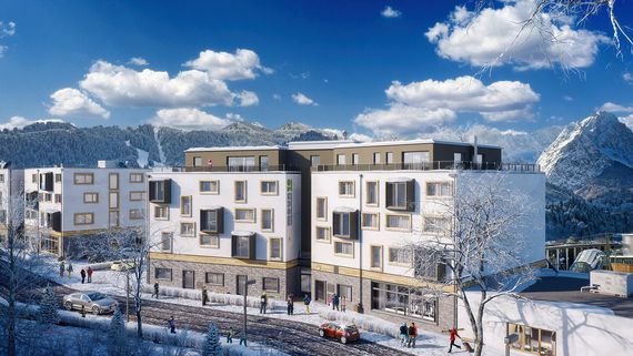 Außenansicht der Jugendherberge moun10 in Garmisch-Partenkirchen im Wnter, mit schneebedeckten Straßen und Bergen
