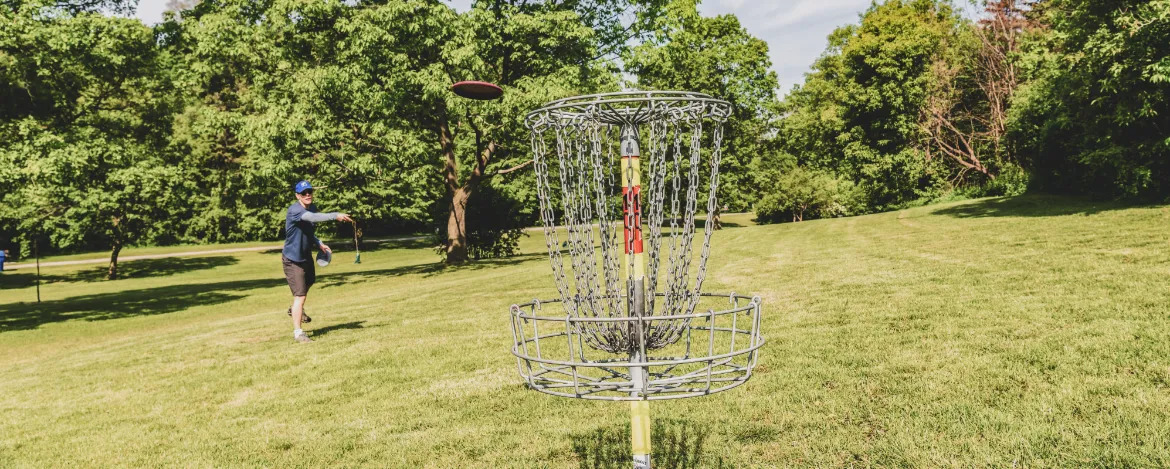 Disc golf is a flying disc sport in which players throw a disc at a target; played using rules like golfs.