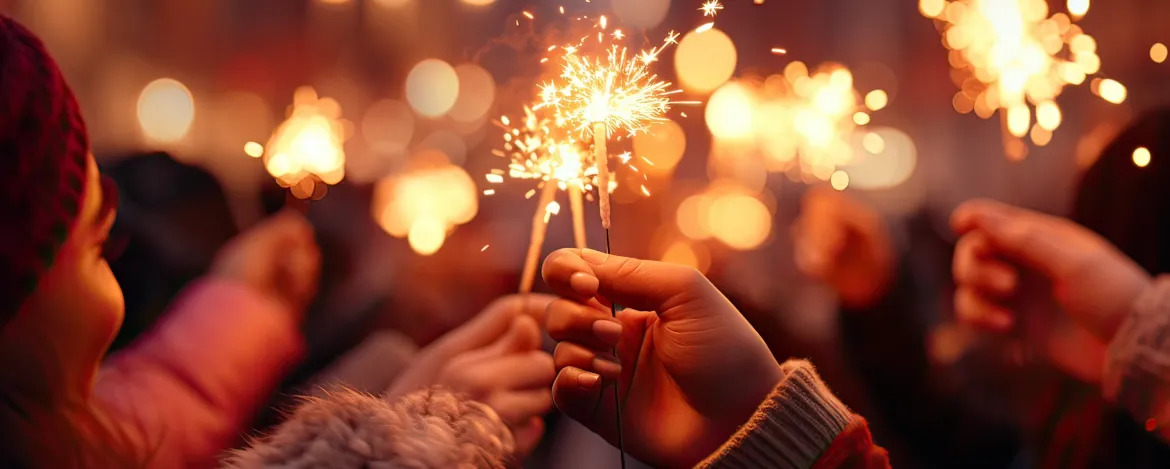 Hands of people holding sparklers outdoors at night, christmas lights on background. Group of friends enjoying out with sparklers. Christmas, New Year's Eve concept. Generative AI.